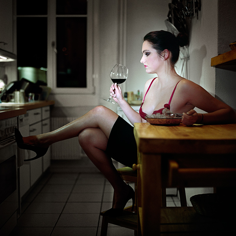 Woman in bra drinking red wine